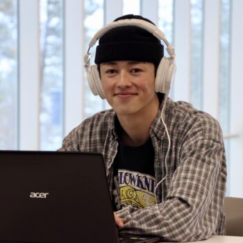 Kai studying on his laptop