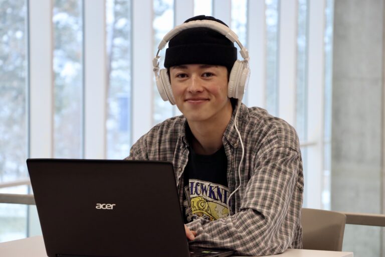 Kai studying on his laptop