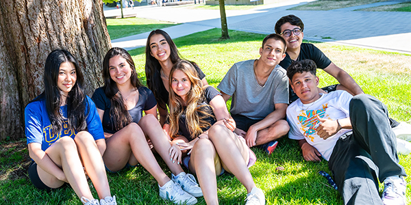 High school students sitting on the grass hanging out