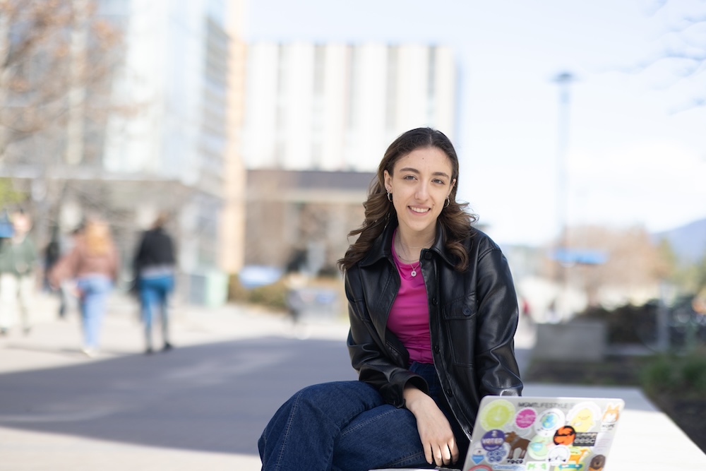 Abby with her laptop on the UBC Okanagan campus