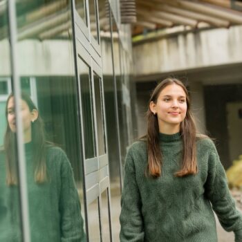 Jamie walking outside the Longhouse on the Vancouver campus