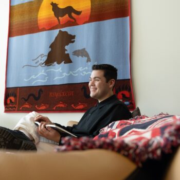 Noah reading a book in the Indigenous Centre