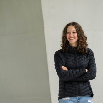 Elleda standing in front of a wall at UBC Vancouver