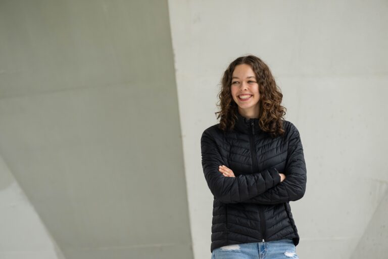 Elleda standing in front of a wall at UBC Vancouver
