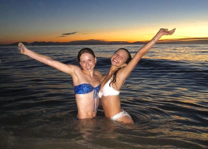 Georgiana and a friend in the ocean at Wreck beach at sunset