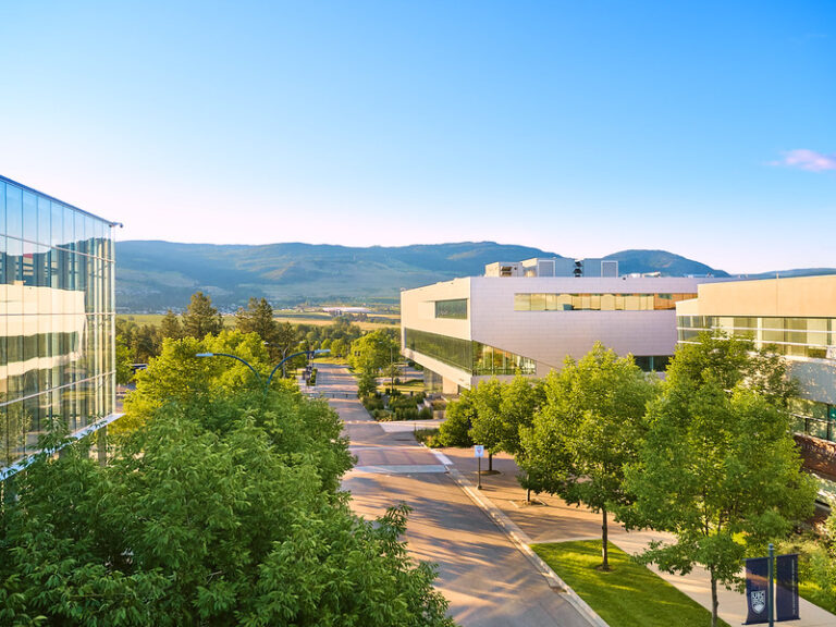 UBC Okanagan aerial view of campus with mountains in the background.